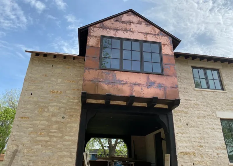Copper metal panel facade on a stone building for Skylight Installation in Rosamond